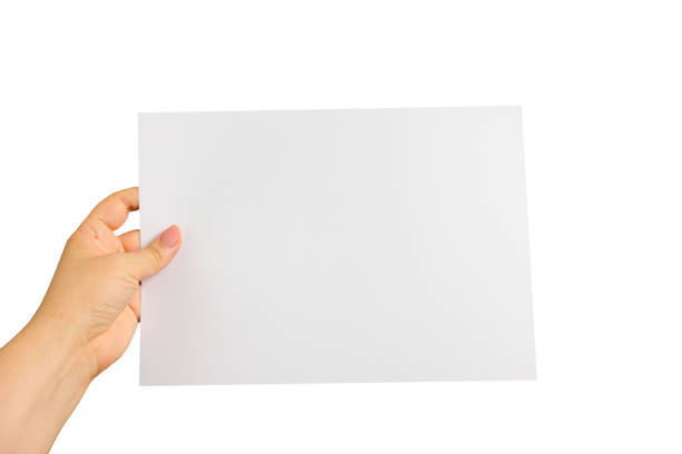 istock A female hand holding an A4 card isolated on a white background. 1432573935