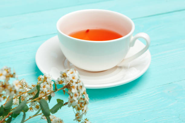 istock Green tea in a ceramic cup with branches of blossoming tree branches 1432574025