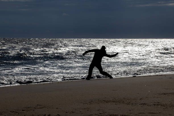 Skipping stones on the beach silhouette