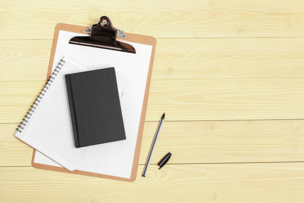 istock Notepad open paper close up on wooden table 1432577660