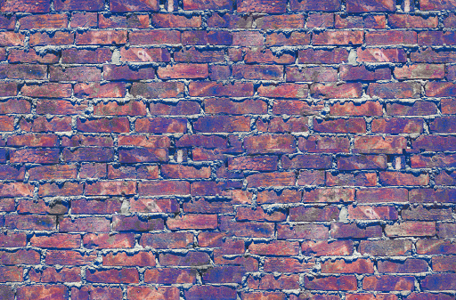 Rough brickwork of the building wall, textured background