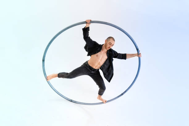 istock Male gymnast doing trick on cyr wheel 1432578773