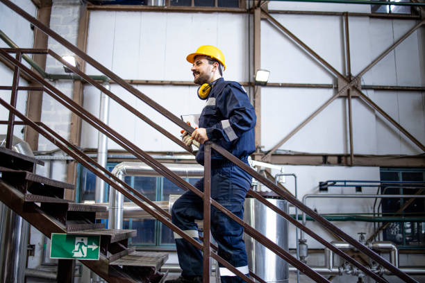 istock Factory worker walking through production plant. 1432578879
