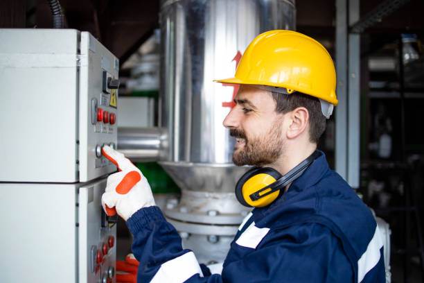 istock Industrial power plant worker standing by electrical cabinet and turning power on. 1432579547
