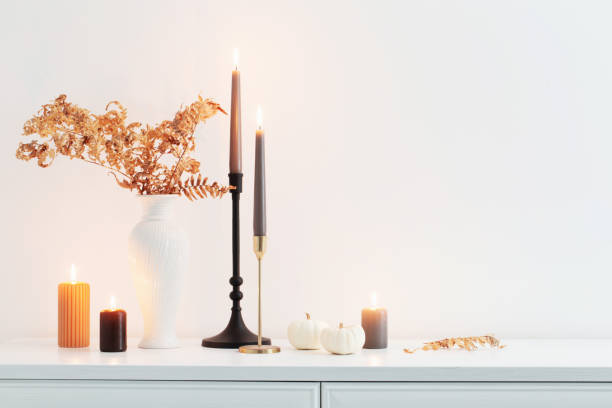istock beautiful autumn home decor with burning candles in white interior 1432579679
