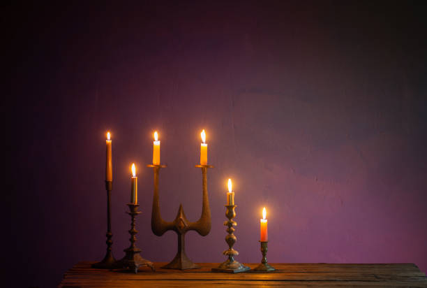 istock burning candles in vintage candlesticks on dark background 1432579684