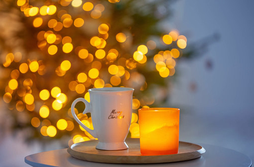 cup with hot drink on background christmas tree