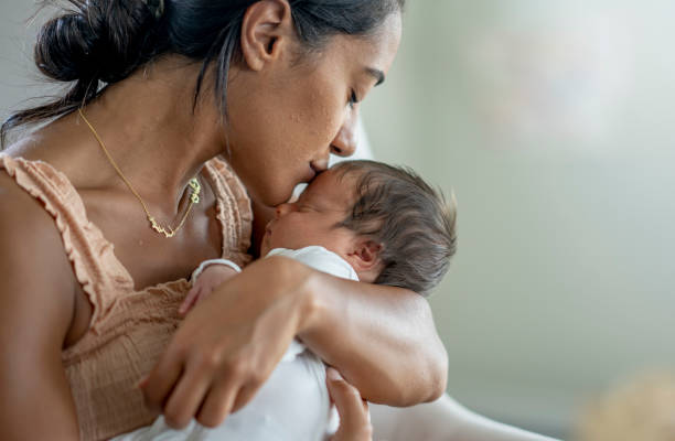 istock Mother Kissing Her Newborns Head 1432580979