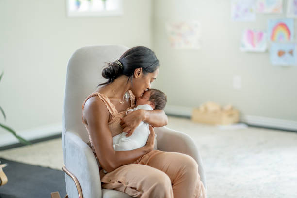 istock Mother Kissing Her Newborns Head 1432580985