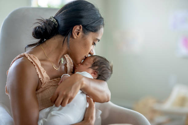 istock Mother Kissing Her Newborns Head 1432581006
