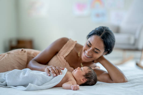 istock Mother Laying with her Infant 1432581016