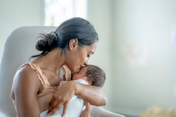 istock Mother Kissing Her Newborns Head 1432581017
