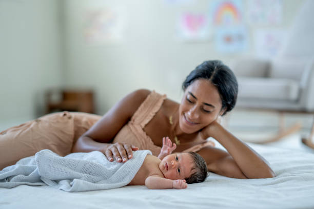 istock Mother Laying with her Infant 1432581029
