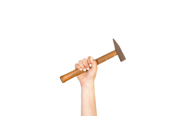 Woman hand holding a hammer on a white background with copy space