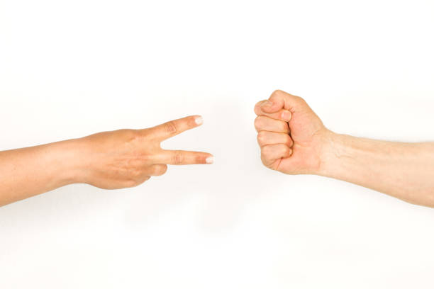 Man and woman hands doing rock, paper, scissors game on a white background with copy space