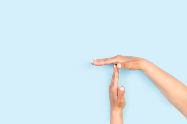 istock Woman hands doing time out gesture on a light blue background 1432582626