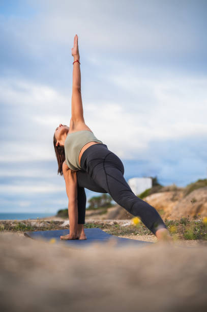 istock Woman practicing yoga in the triangle position. 1432583037