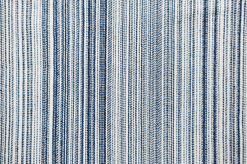 Denim jeans texture with blue vertical stripes.