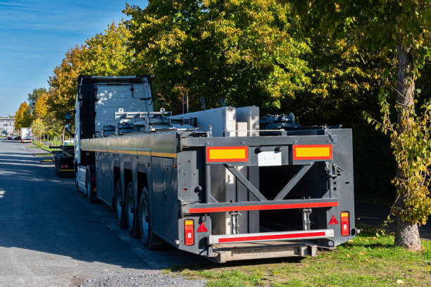 truck with flatbed trailer parked roadside