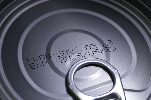Close up image of production and expiry dates on canned food