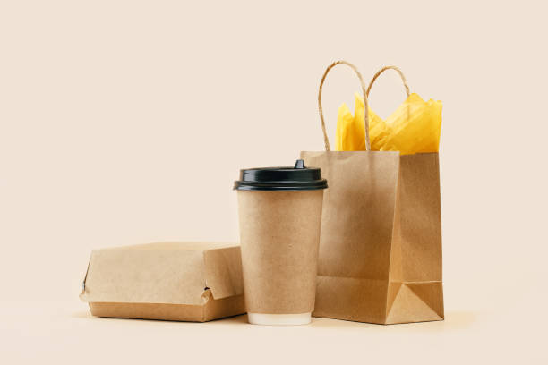 istock Takeaway paper coffee cup with lunch bag on beige 1432589741