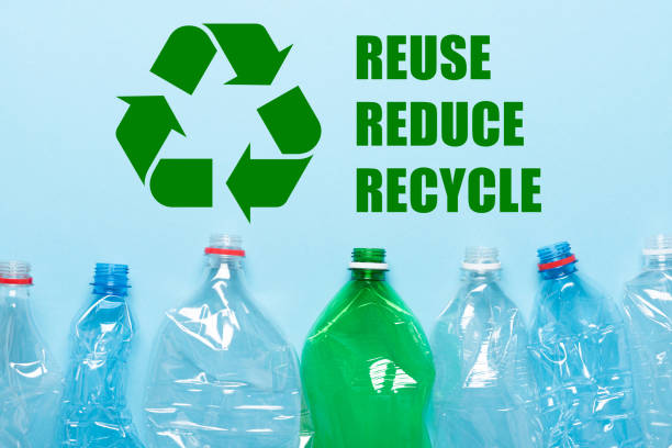 istock Recycling symbol with recycle reduce reuse words and empty plastic bottles on blue background 1432590117