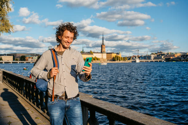 istock Young Man Using Phone On The Quayside In The City 1432591552