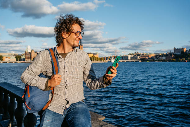 istock Young Man Using Phone On The Quayside In The City 1432591635