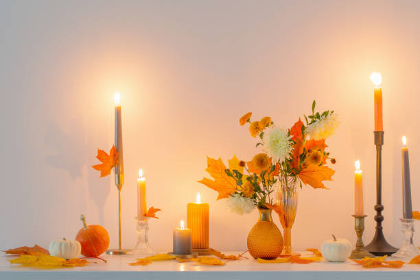 istock beautiful autumn home decor with burning candles in white interior 1432591819