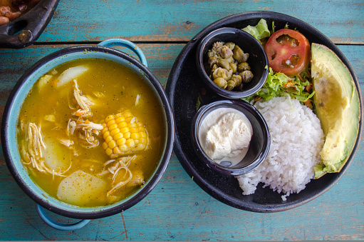 Ajiaco - A traditional colombian soup of chicken, pototoes and corn garnished with capers, avacodo and cream