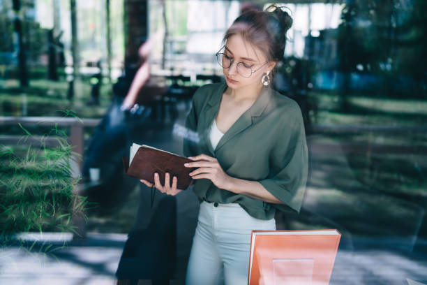 istock Pensive woman reading notebook in office 1432593364