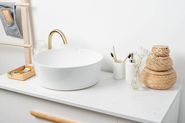 istock Bathroom marble counter with sink, candles and toothbrushes near white wall, copy space 1432594372