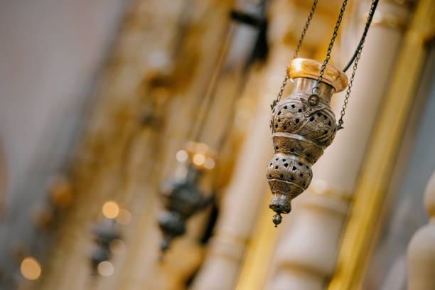 Hanging lit vigil light in front of the eastern orthodox icon