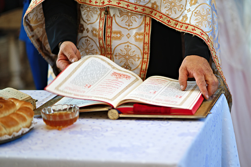 Orthodox priest reading a prayer in an orthodox church