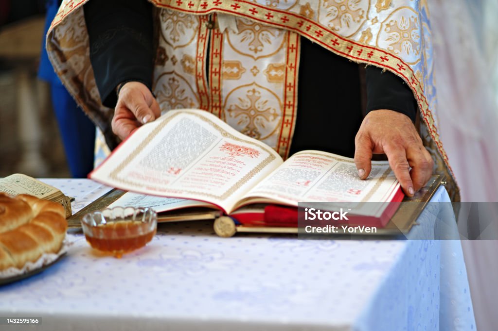 Orthodox religion. Hands of the priest on the bible. Orthodox priest reading a prayer in an orthodox church Adult Stock Photo