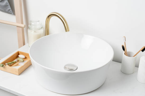 istock Bathroom marble counter with sink, candles and toothbrushes near white wall, copy space 1432595702