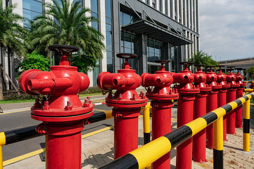 A row of red fire hydrants outdoors