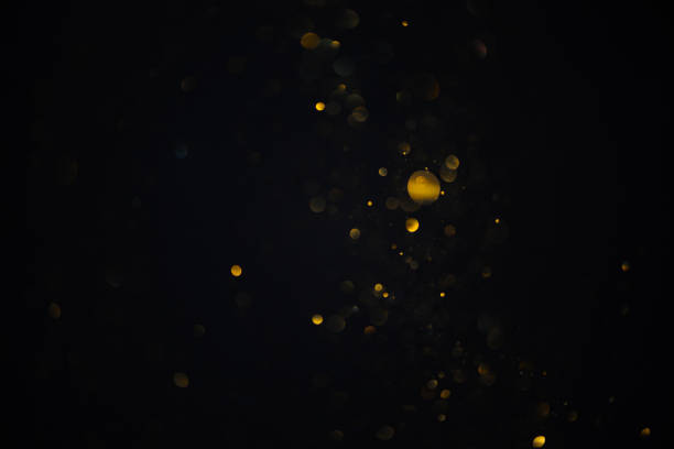istock Few golden glitter bokeh sparkles lights dark abstract overlay 1432602637