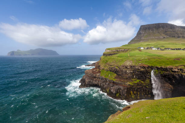 istock sunny day at mulafossur waterfall, faroe islands 1432603315