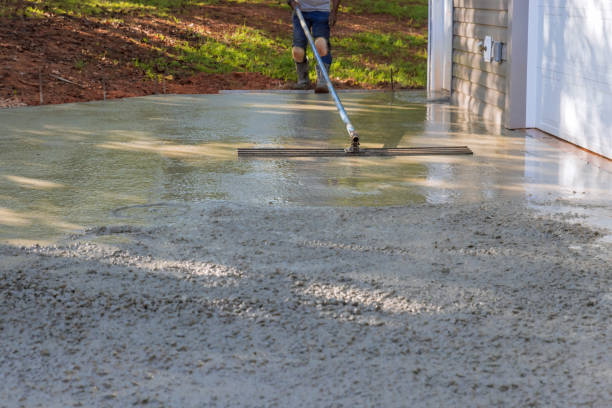 istock Mason worker leveling concrete patio floor using a long trowel 1432604940
