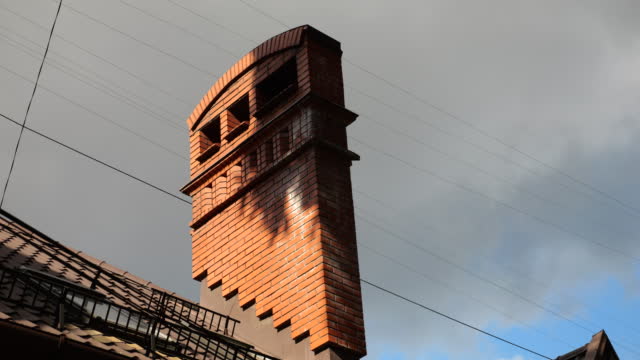 Chimney on the roof of the building. Architecture of an old European city.
