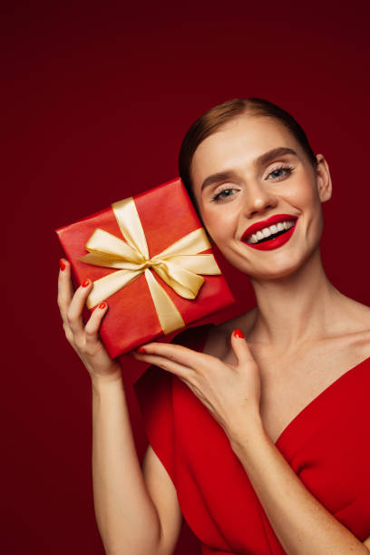 istock Beautiful emotional woman holding present box 1432608720