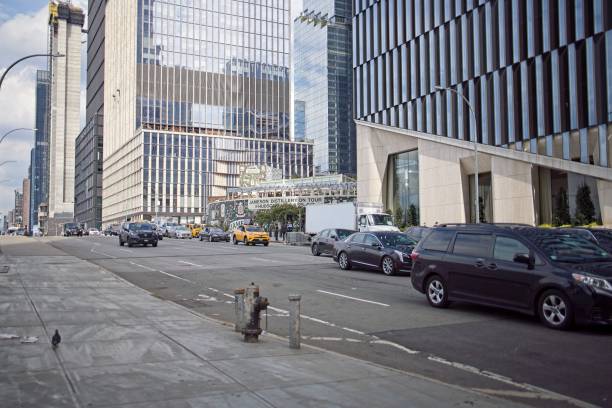 New York, NY, USA - Oct 11, 2022: Side view of towers at Hudson Yards along with traffic on 11th Ave on a partly cloudy Fall day.