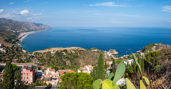 Taormina, Italy: 09-16-2022: Aerial wide angle view of Taormina and its beautiful coastline