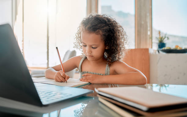 istock Zoom class, home school lesson and online education with little kid writing homework and test for distance learning on video call laptop. Child, young girl and student studying with virtual teaching 1432610953