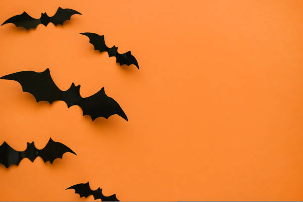 istock Bright orange background with black bats and place for text. 1432611066