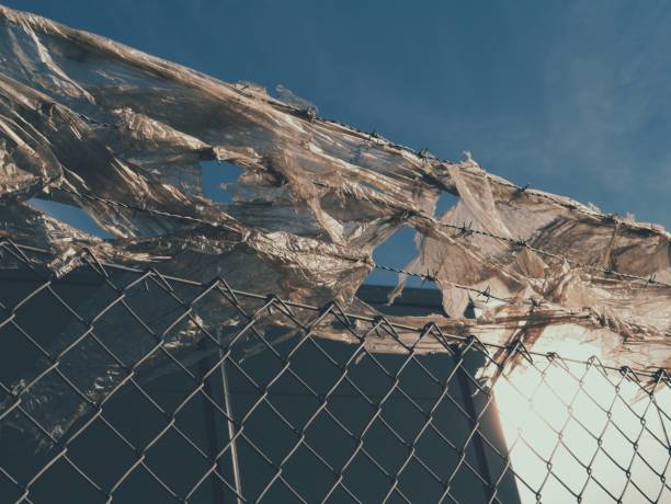 istock Low angle view of fence with old plastic bags 1432612244