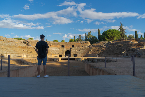 Merida, Spain; September 1 - 2020: A person looks at the ancient Roman amphitheatre of Merida.