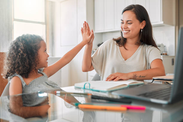 istock High five, homework and mom celebrating with preschool student for learning, goals and writing notes successfully. Teamwork, smile, and happy mom celebrates education with her kindergarten baby girl 1432612918