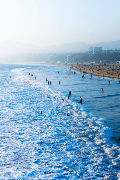 people playing in the ocean - santa monica beach beach california wave imagens e fotografias de stock